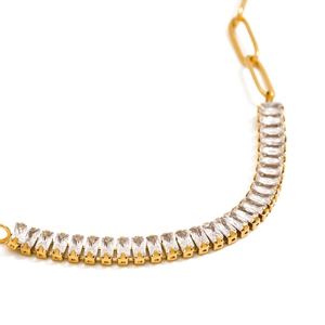 Detailed macro view of 18k gold plated paperclip chain with rectangular zircon stones