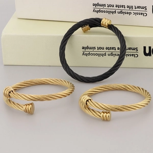 Classic twisted cable bangle set in gold and black stainless steel with textured design