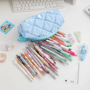 Quilted light blue pencil case with large capacity showing various stationery items