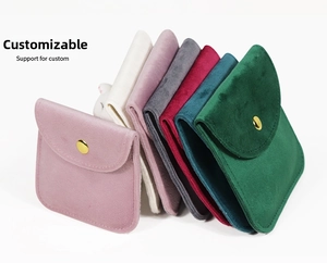 Detail of velvet jewelry pouches with gold snap buttons in various vibrant colors