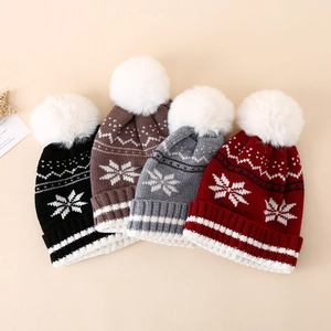 Winter knit hats for kids with festive snowflake patterns and soft white pom-poms