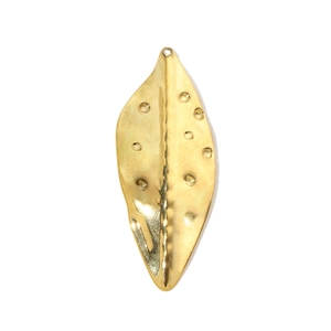 Macro detail of golden hammered texture on leaf-shaped stainless steel pendant