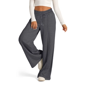 Detail shot of dark grey wide leg trousers featuring a drawstring waist and knitted texture