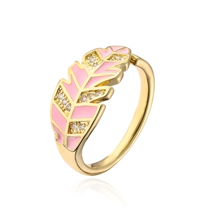 Macro view of gold-plated leaf ring featuring pink enamel and zircon inlay detail