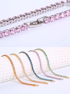 Macro detail of multi-color tennis bracelets with zircon inlay and secure fold-over clasps