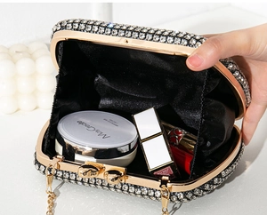 Interior detail of sparkling rhinestone evening clutch showing capacity for lipstick and compact