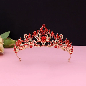 Detailed macro of vintage baroque gold crown with inlaid red rhinestones for wedding