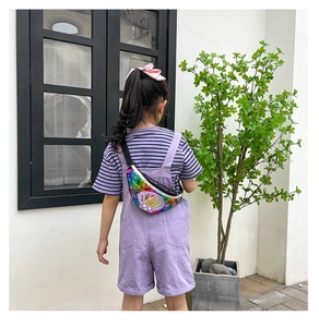 Close-up of shell-shaped sequin bag worn by child model with pearl accents