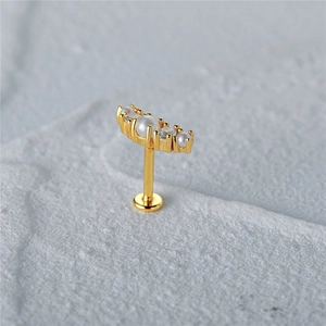 Detailed close-up of golden S925 sterling silver butterfly earring with pearls and zircon