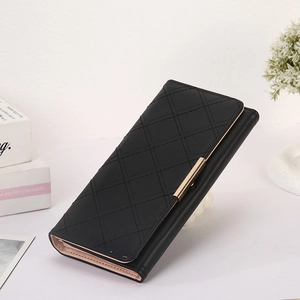 Detailed side view of long black quilted wallet with golden metal bar and pink lining