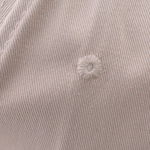 Macro shot of embroidered ventilation eyelets on the high-quality twill cotton baseball cap