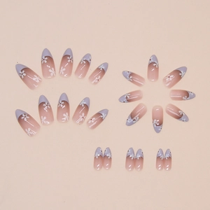 Short almond press-on nails with nude gradient, lavender French tips and white daisy prints