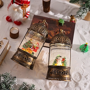 Detail of vintage bronze Christmas lanterns featuring Santa and snowman miniature scenes