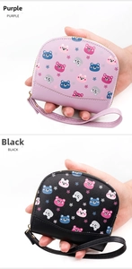 Detail view of purple and black PU leather wallets with cute cartoon bear patterns