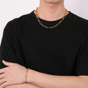 Men's gold plated stainless steel curb chain necklace and bracelet set on black shirt