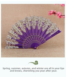 Detail showing purple lace folding fan with sparkling gold floral patterns and gold metal ring
