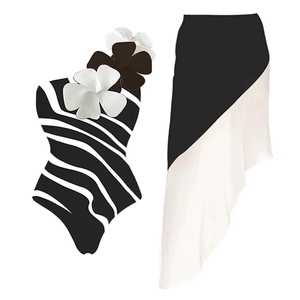Detail of zebra stripe one-piece swimsuit featuring 3D floral accents and matching sarong