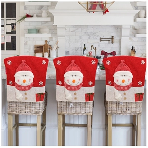 Detailed embroidery of snowman on a festive red and beige linen chair back cover