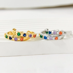 Main view of gold and silver C-shaped hoop earrings with colorful zircon stone inlay