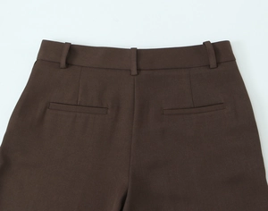 Detail of high waist back, belt loops and pockets on dark brown autumn suit trousers