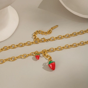 18K gold plated stainless steel necklace with red enamel strawberry charms on white stone