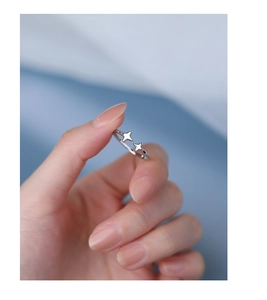 Macro detail of silver S925 sterling silver open ring with micro-set zircon stars