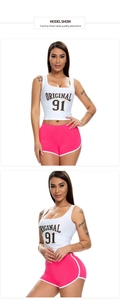 Close-up of pink high-elastic sports shorts with white trim and athletic tank top