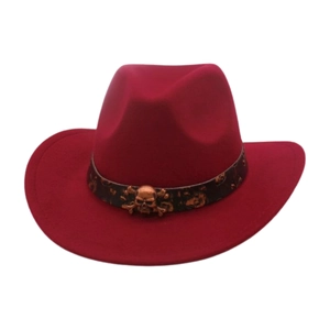 Detailed view of a dark red felt cowboy hat featuring a bronze skull metal emblem
