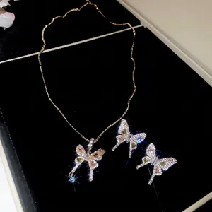 Elegant gold butterfly jewelry set with green gemstones and white zircon stones