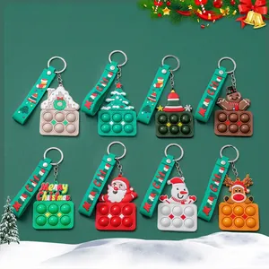 Variety set of Christmas Pop It silicone keychains featuring Santa, reindeer and tree designs