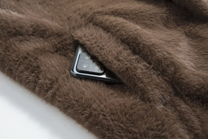 Close-up of invisible side pocket on a brown faux mink fur long coat for men