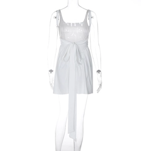 Detail view of white mini dress with thin straps and waist bow on clear mannequin