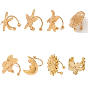 8-piece set of gold metallic ear clips with starfish, moon, sun, and flower designs