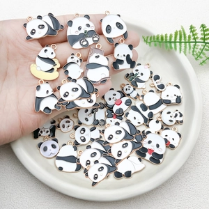 Detailed close-up of cute panda enamel pendants for DIY jewelry and keychain accessories