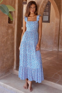 Detailed view of tiered bohemian floral dress with ruffled straps in light blue