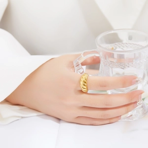 French retro gold plated stainless steel croissant ring worn on hand with a glass cup