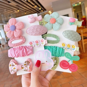 Close-up of cute pink and green fabric hair clips for girls on display cards