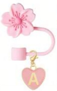 Detailed view of pink cherry blossom straw topper with golden letter A heart pendant charm
