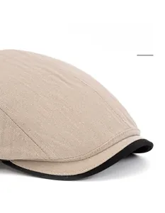 Close-up of herringbone fabric texture and adjustable black brim on men's newsboy hat