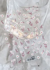 Macro shot of self-adhesive floral nail stickers with white and pink flower designs