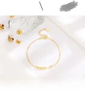 Close-up of minimalist S925 sterling silver gold beaded bracelet with lobster clasp