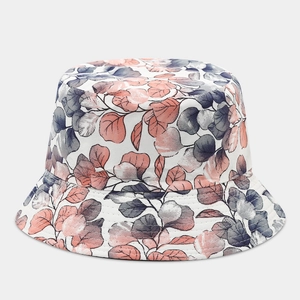 Detailed view of bucket hat stitching with pink and blue artistic leaf patterns