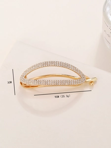 Detailed view of golden rhinestone metal hair clip with 9cm length and 3cm height