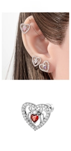 Detailed close-up of heart-shaped spider cartilage studs with colorful center stones