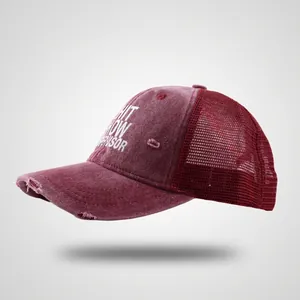 Vintage burgundy trucker hat with washed denim, mesh back, and distressed ripped brim detail