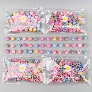 Macro shot of colorful mini macaron hair clips in star and flower shapes with packaging