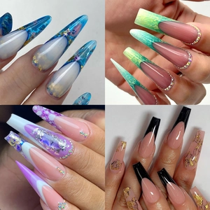 Detailed view of long stiletto and coffin false nails with rhinestones and gold foil