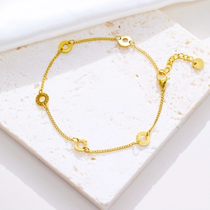 Detail of golden stainless steel chain featuring five Roman numeral engraved ring pendants