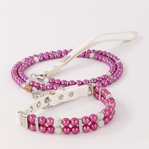 Detail of rose purple pearl pet collar set with rhinestone accents and white leather