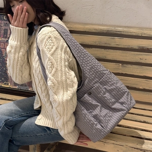 Detail of purple gingham tote bag featuring wide shoulder strap and front pocket with buckle